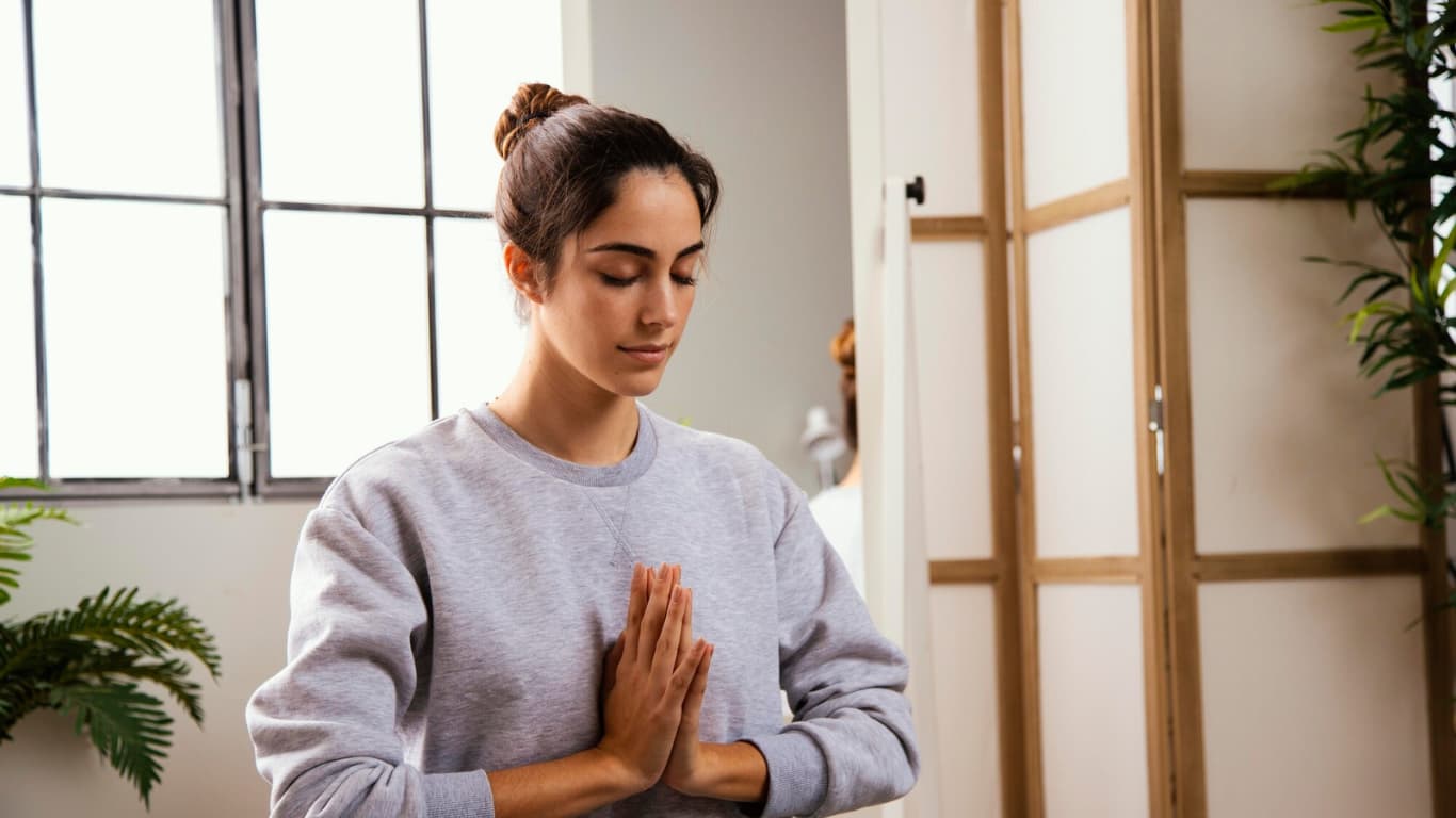Persona meditando sentada beneficios de la meditación